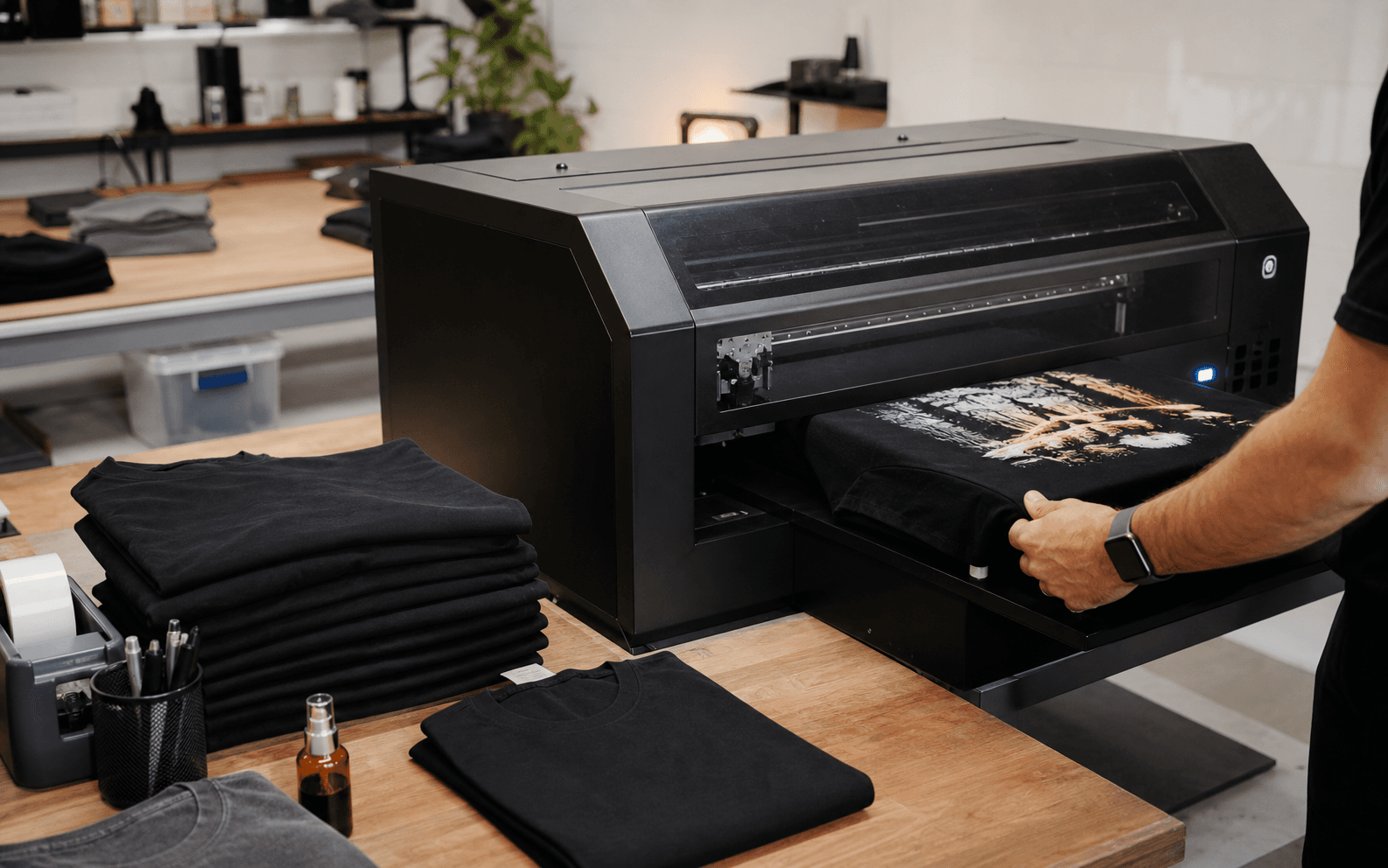 Custom apparel production floor with a shirt being printed